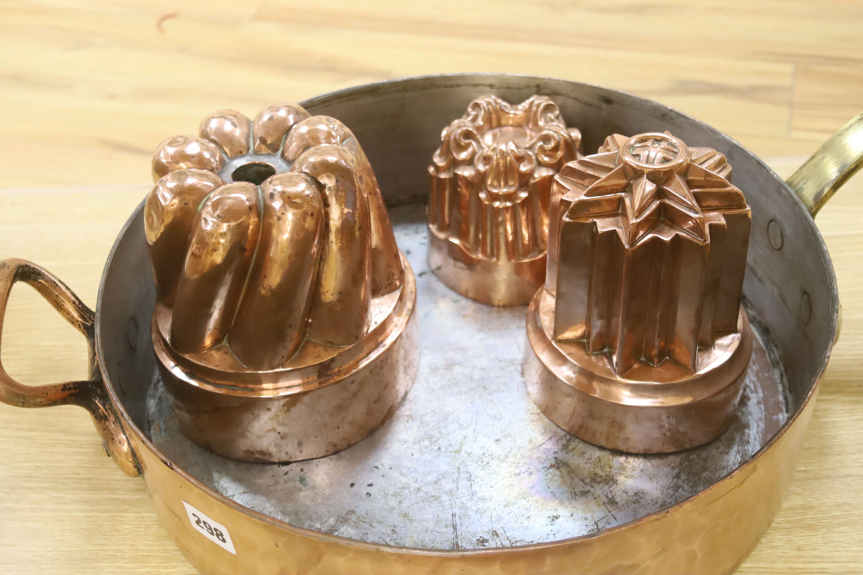 A Victorian Benham & Froude copper jelly mould, 11cm high, two others, 16.5cm high and a copper preserving pan